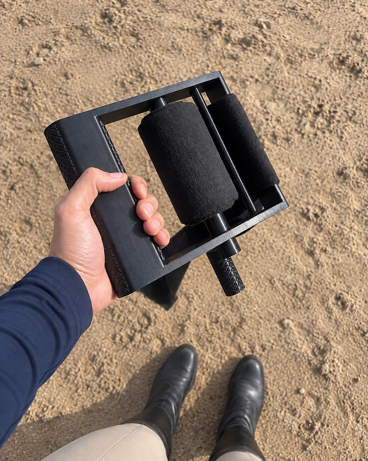 Rider holding the roller with two rolled black wraps on the handle